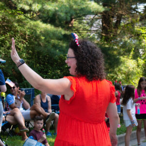 Amy Brooks waving to people while walking the parade