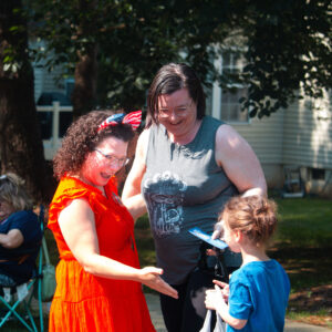 Amy Brooks speaking to a mom and her child