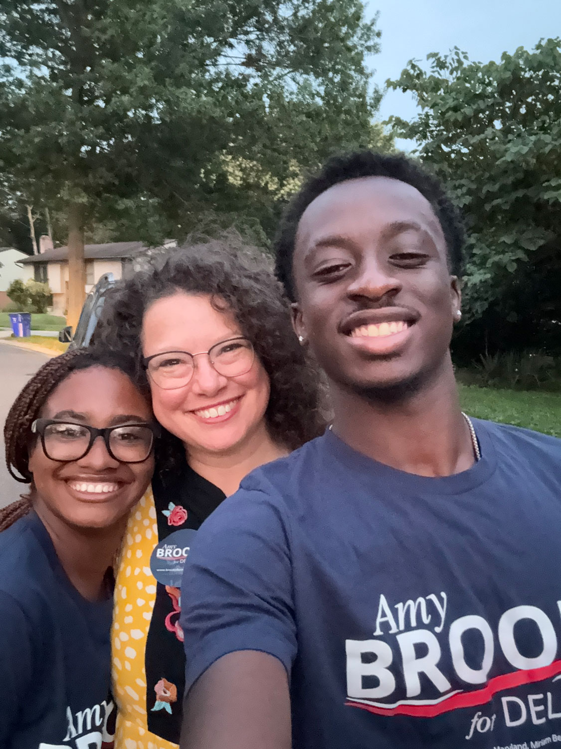 Amy Brooks with two students wearing a "Amy Brooks for Delegate" shirt