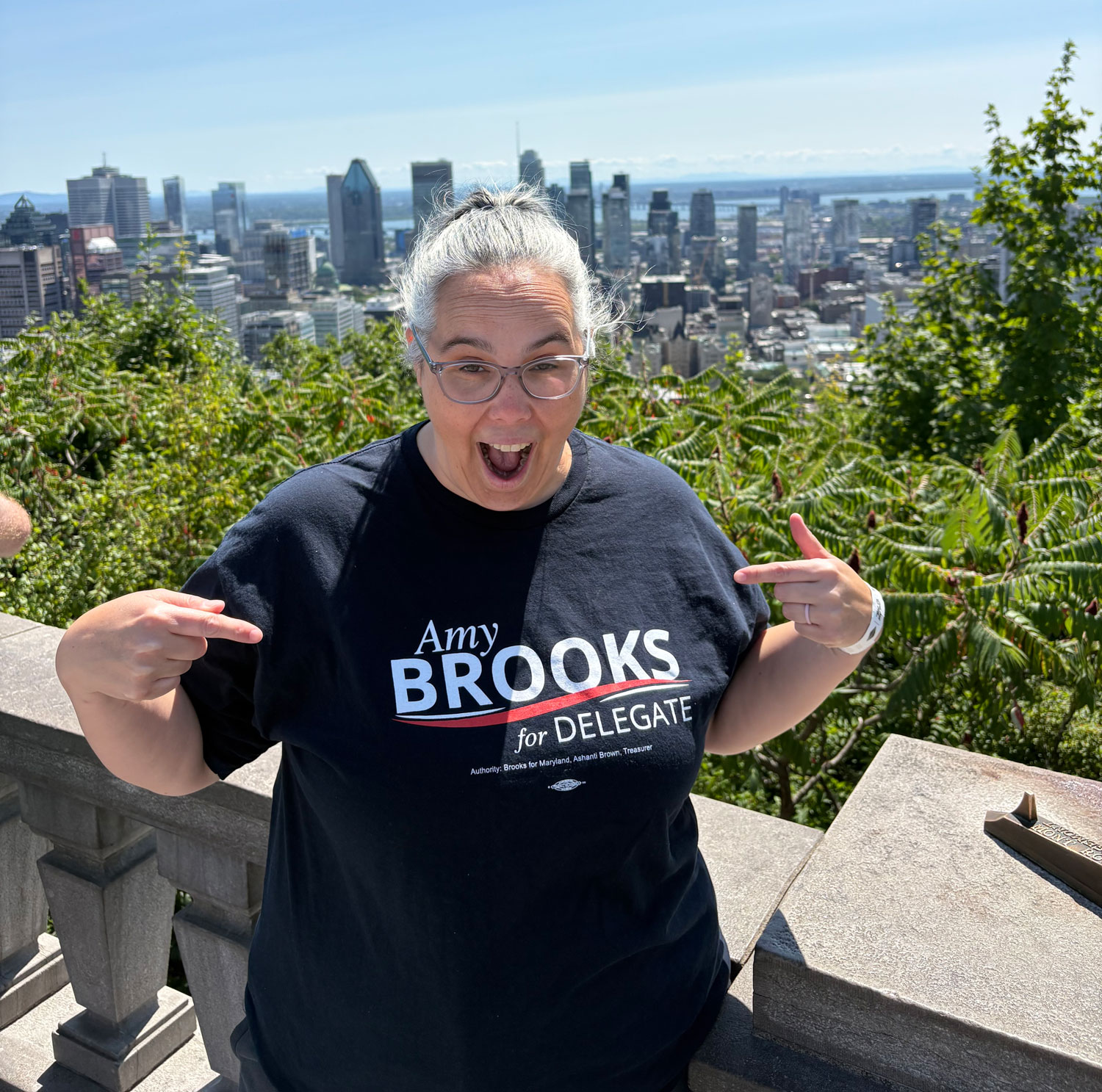 Supporter smiling and pointing at her "Amy Brooks for Delegate" shirt