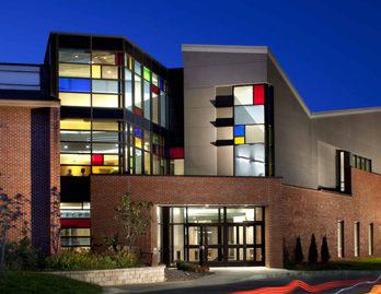 Owen Brown Interfaith Center at night with stained glass backlit